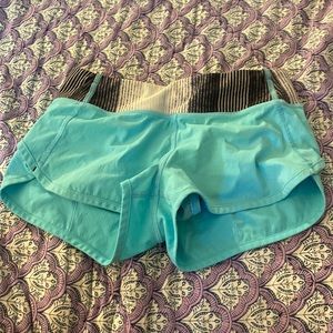 very pretty teal ivivva shorts with a black and white waist band, size 10